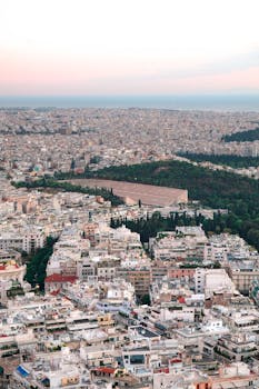 A breathtaking aerial view of Athens, Greece, showcasing the sprawling urban landscape at dusk.
