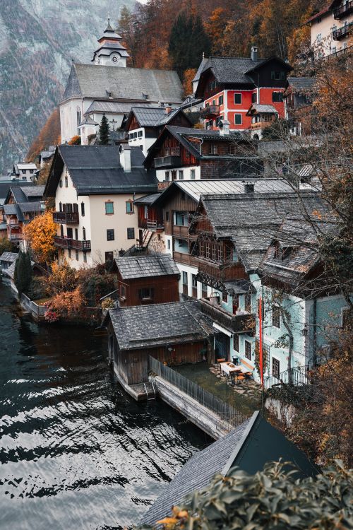Free Picturesque autumn scene of Hallstatt's waterfront with colorful buildings reflecting on Lake Hallstatt. Stock Photo