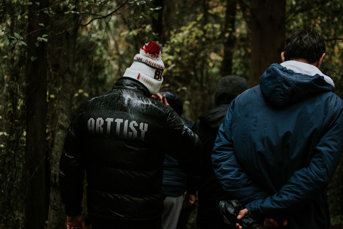 Men walking together through a woodland path