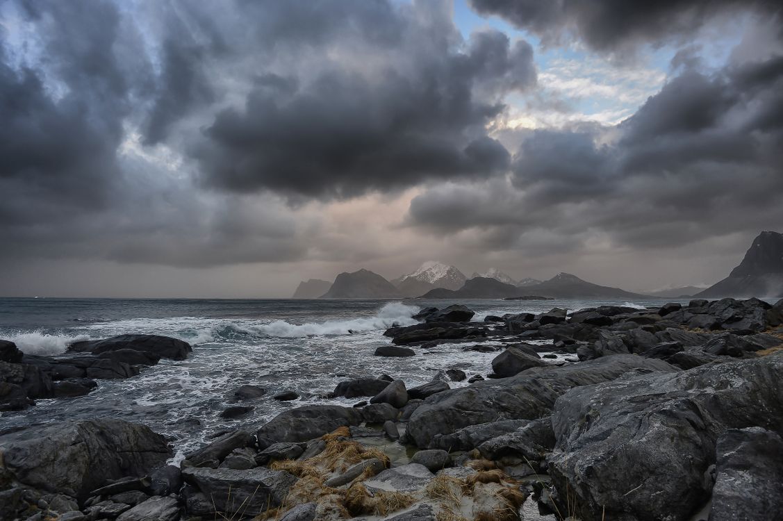 Gray Rocks on the Shore under the Cloudy Sky · Free Stock Photo