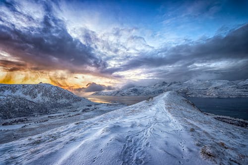 Snow Covered Mountain Beside the Ocean