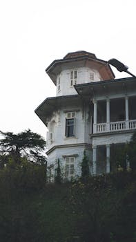 Charming Victorian architecture featuring a white facade with intricate details and a wraparound balcony.
