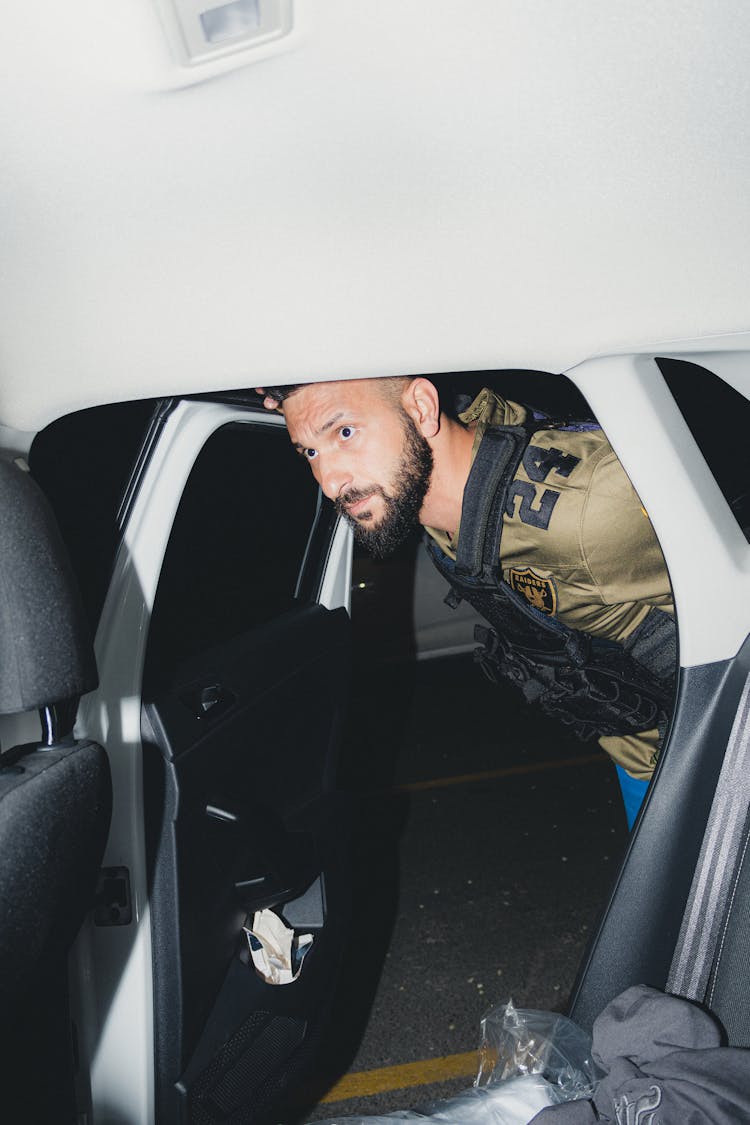 Man Entering Into Backseat Of Car