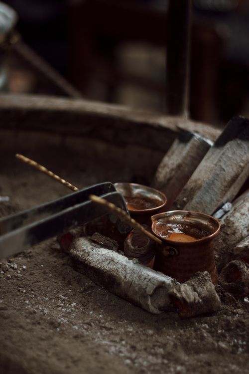 Free Authentic Turkish coffee prepared using sand brewing method in clay cezve pots. Stock Photo
