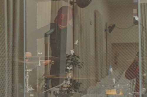 Man Standing Front of Drum in Room