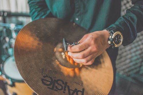 Person Holding Paiste Cymbal