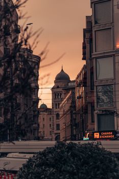 A scenic urban sunset highlighting historic buildings with intricate architecture.