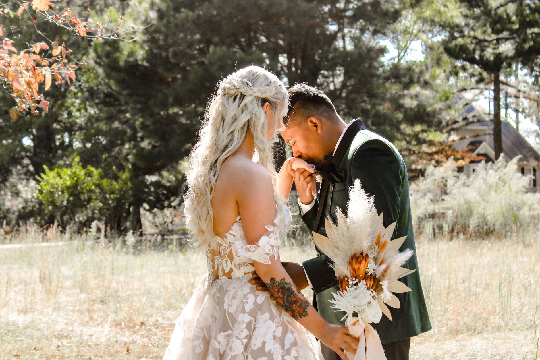 Couple at a romantic outdoor wedding surrounded by greenery