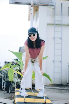 Woman in casual outfit with sunglasses posing outdoors in Cimahi, Indonesia.