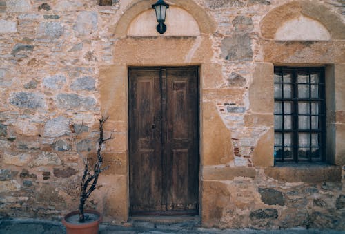 Building with Stone Wall and Brown Wooden Door