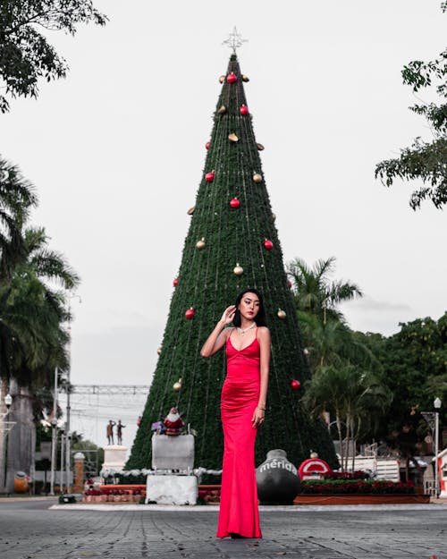 Model in Red Dress by Christmas Tree