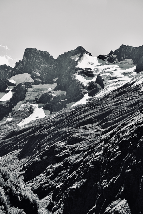 Free A dramatic snow-covered mountain landscape captured in striking black and white. Stock Photo
