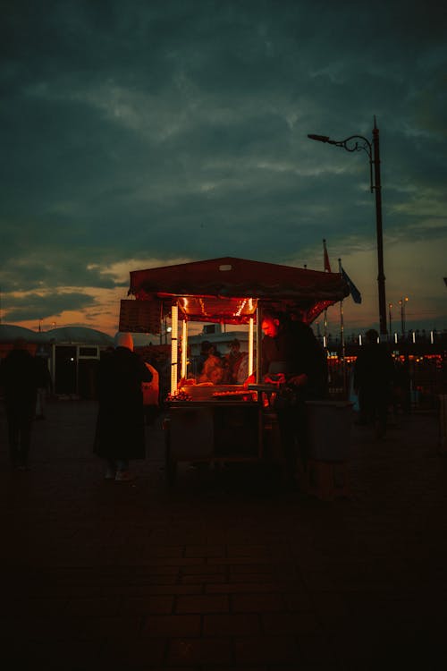 Illuminated Food Stand at Dusk