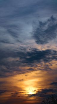 Stunning golden hour sunset with dramatic, colorful sky and cloud formations.