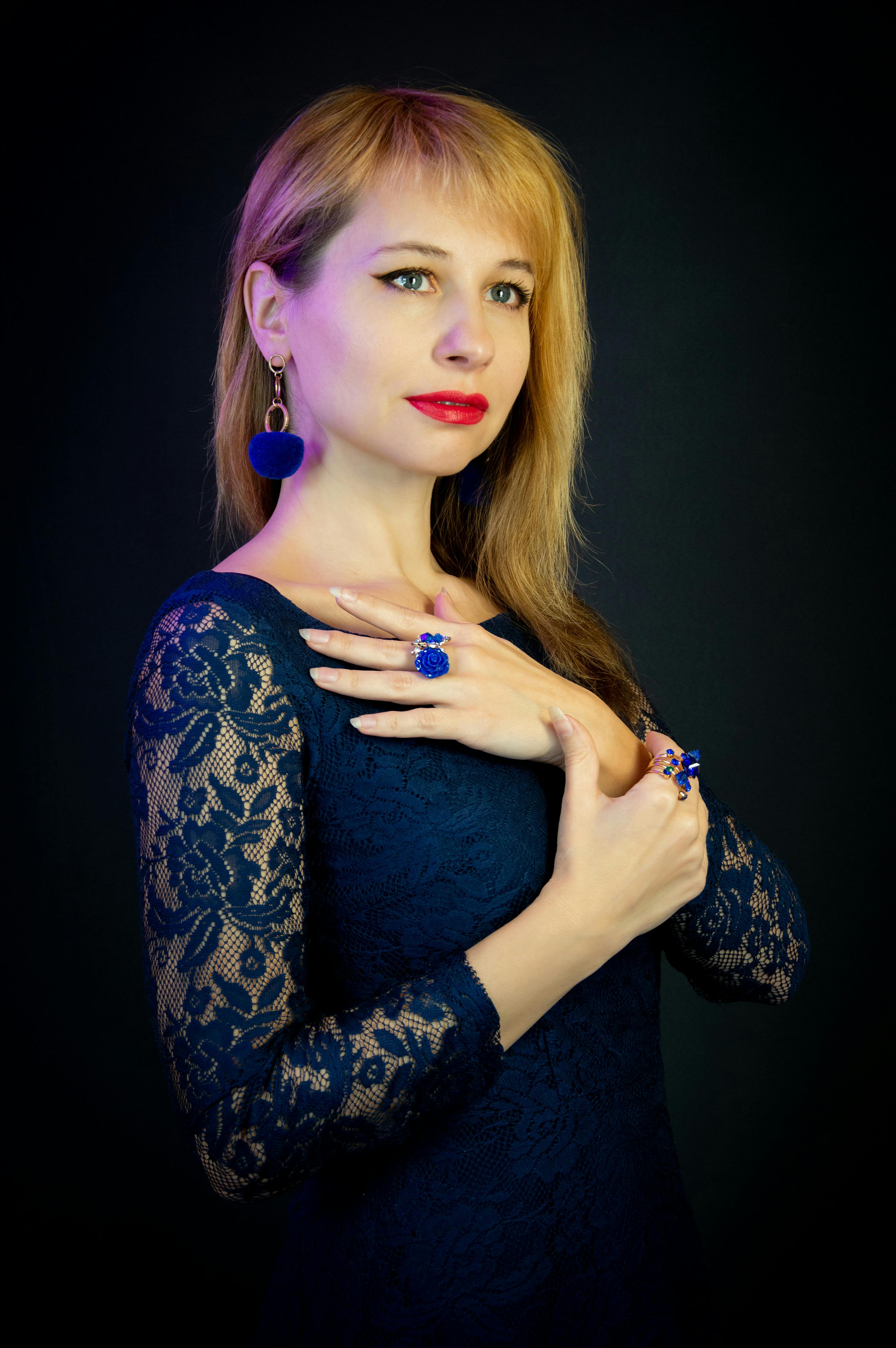 A sophisticated studio portrait of a stylish woman in a blue dress showcasing elegance and modern fashion.