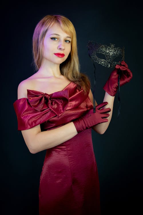 Woman in an Evening Dress Holding a Carnival Mask