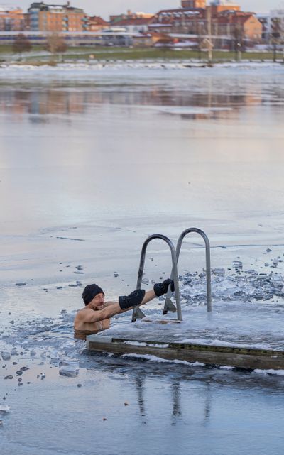 Swimmer in an icy lake, blurred for privacy, photo by Olavi Anttila on Pexels