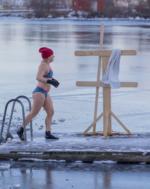 Woman in Bikini Walking on Frozen Boardwalk