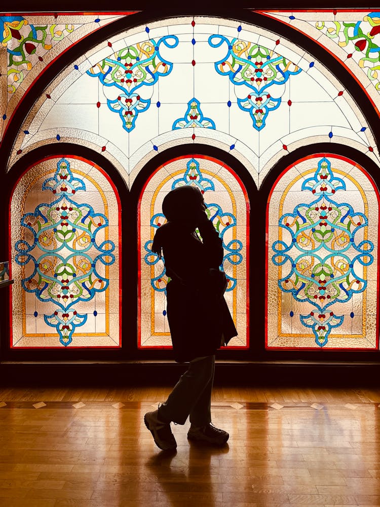 Silhouette Of Woman On Stained Glass Window