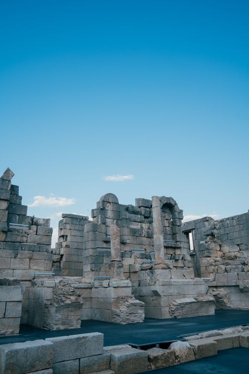 Free Explore ancient stone ruins with historical significance under a clear blue summer sky. Stock Photo