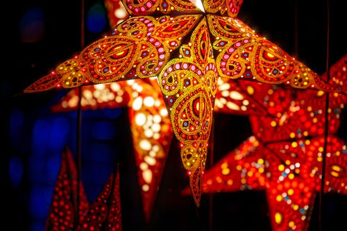 Free Colorful star-shaped lanterns illuminating with intricate patterns at night. Stock Photo