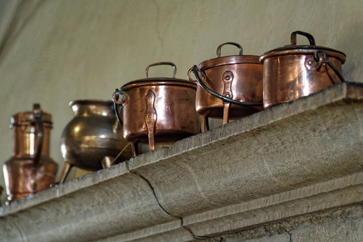 Brass Pots On A Concrete Shelf