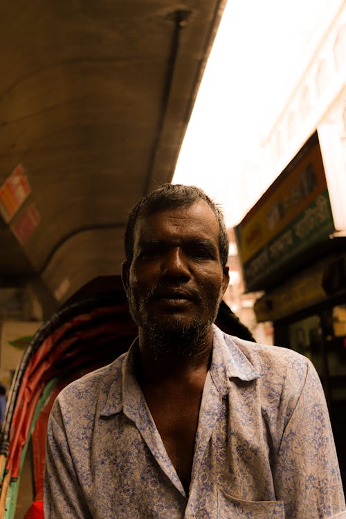 Portrait of a Man in a Shirt on a Street Market 