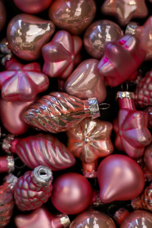 Free A close-up of assorted pink Christmas ornaments with festive shapes and glossy finishes. Stock Photo