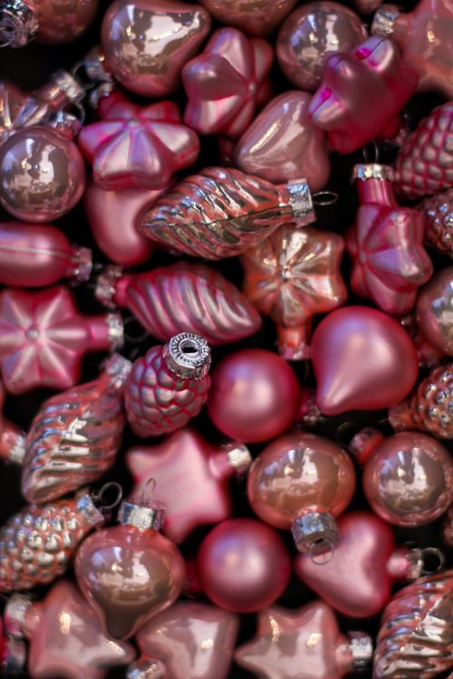 Free A vibrant collection of pink Christmas ornaments in various shapes. Ideal for festive displays. Stock Photo