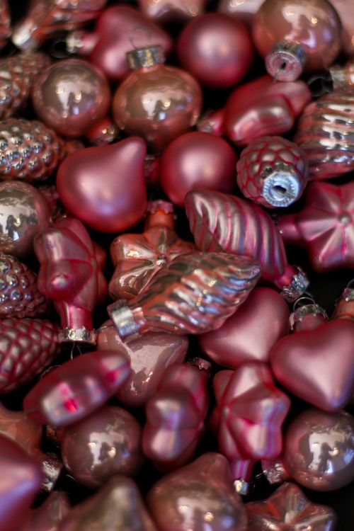 Free A collection of shiny pink Christmas ornaments in various shapes, perfect for festive decorations. Stock Photo