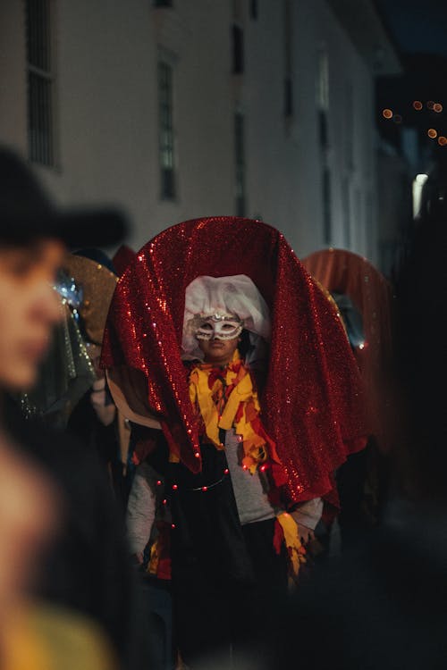 Woman in Traditional, Colorful Clothing at Night Parade