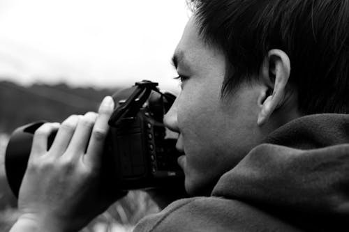Monochrome Shot of a Photographer Taking Photos