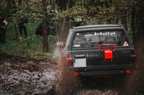 A suv driving through a muddy area