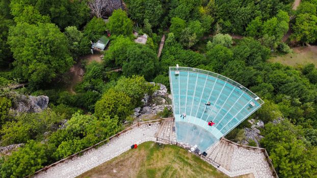 Stunning aerial shot of a glass observation platform amidst lush greenery in Karabük, Turkey.