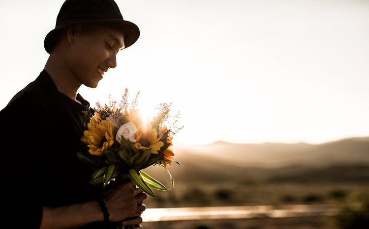 A Man Holding A Bouquet