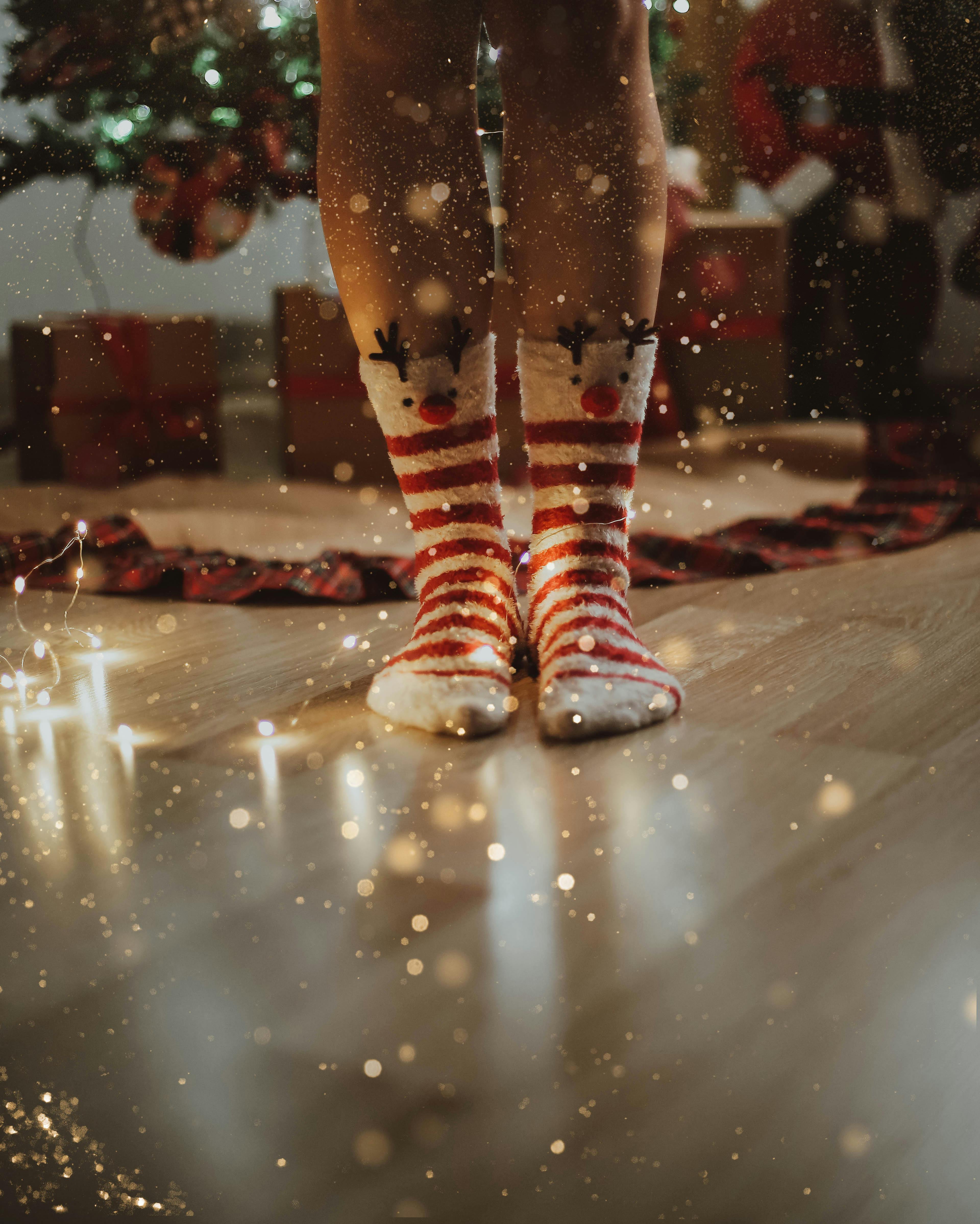 a person wearing red and white christmas socks