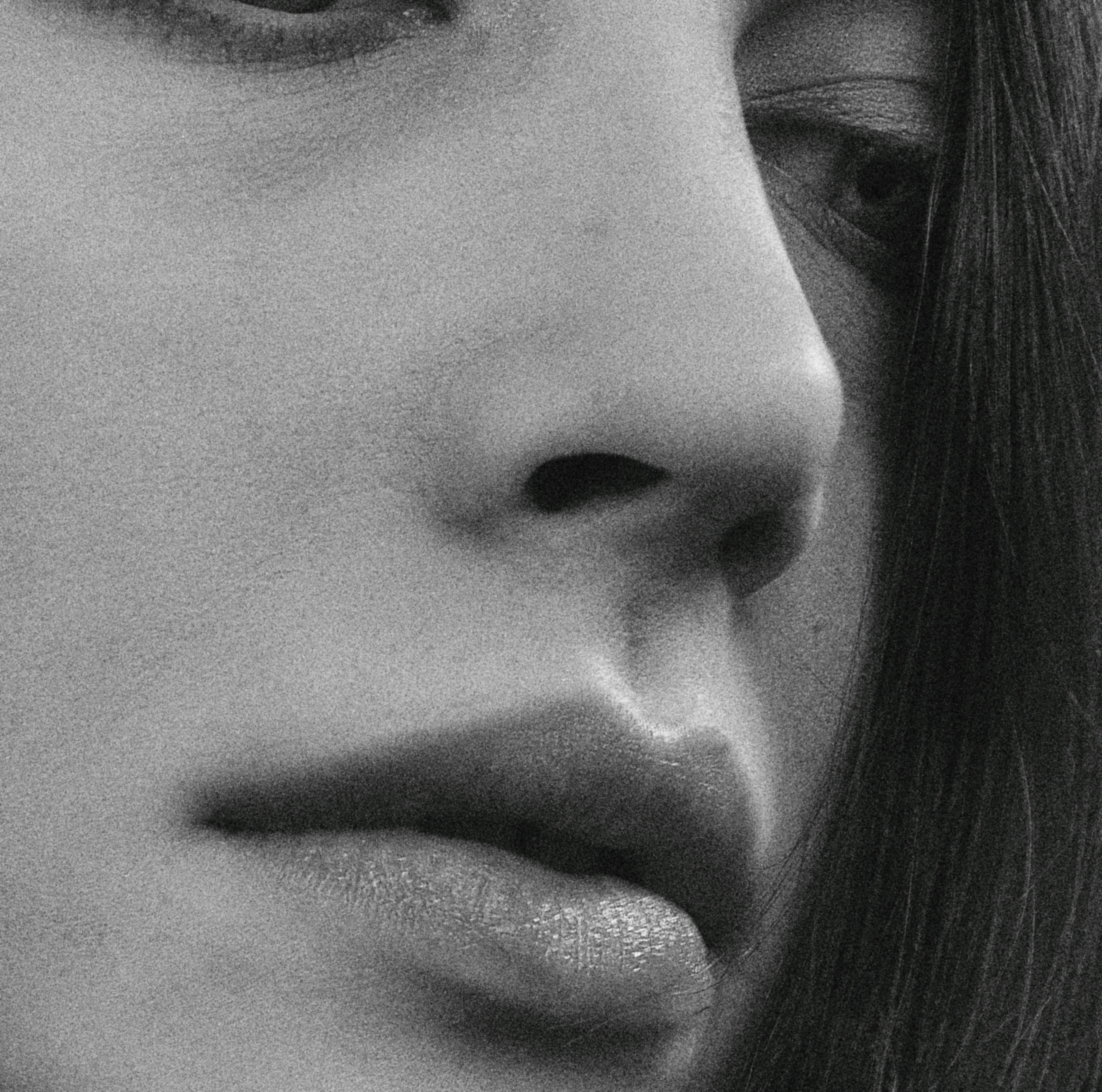 Monochrome close-up of a woman face highlighting detail and texture