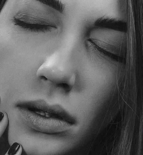 Free Intimate black and white portrait of a woman with closed eyes, showing serene expression. Stock Photo