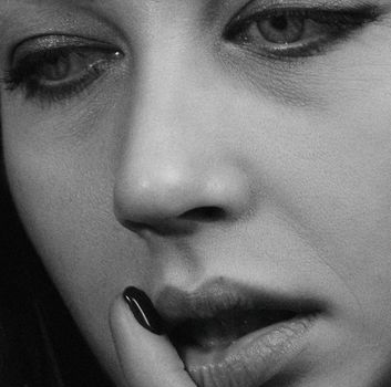 Intimate black and white shot capturing the subtle emotion on a woman's face.