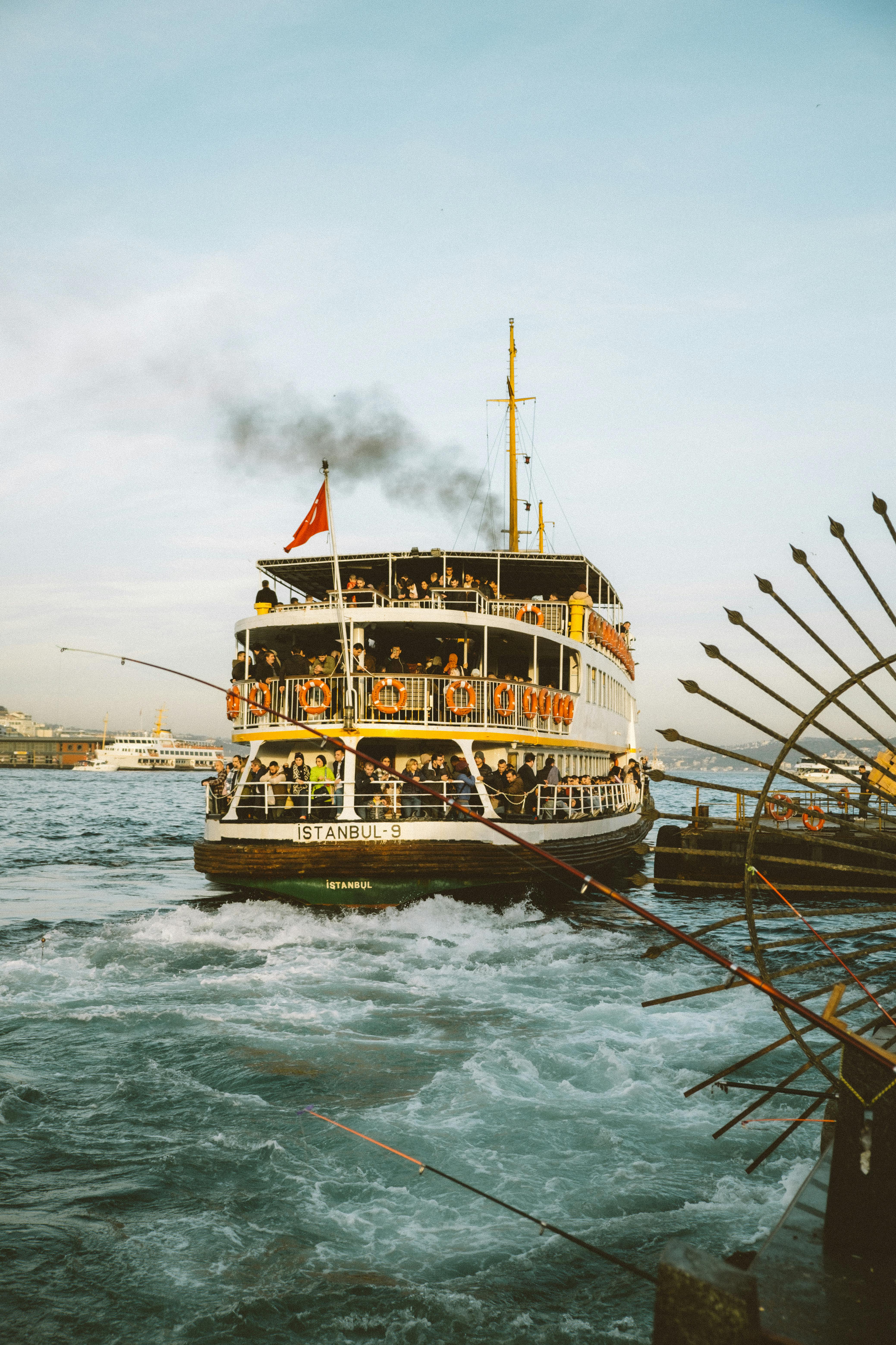 A boat traveling through the water with smoke coming out of it · Free