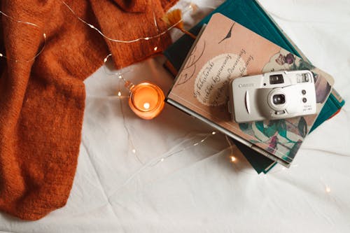 High Angle View of a Candle and a Camera 