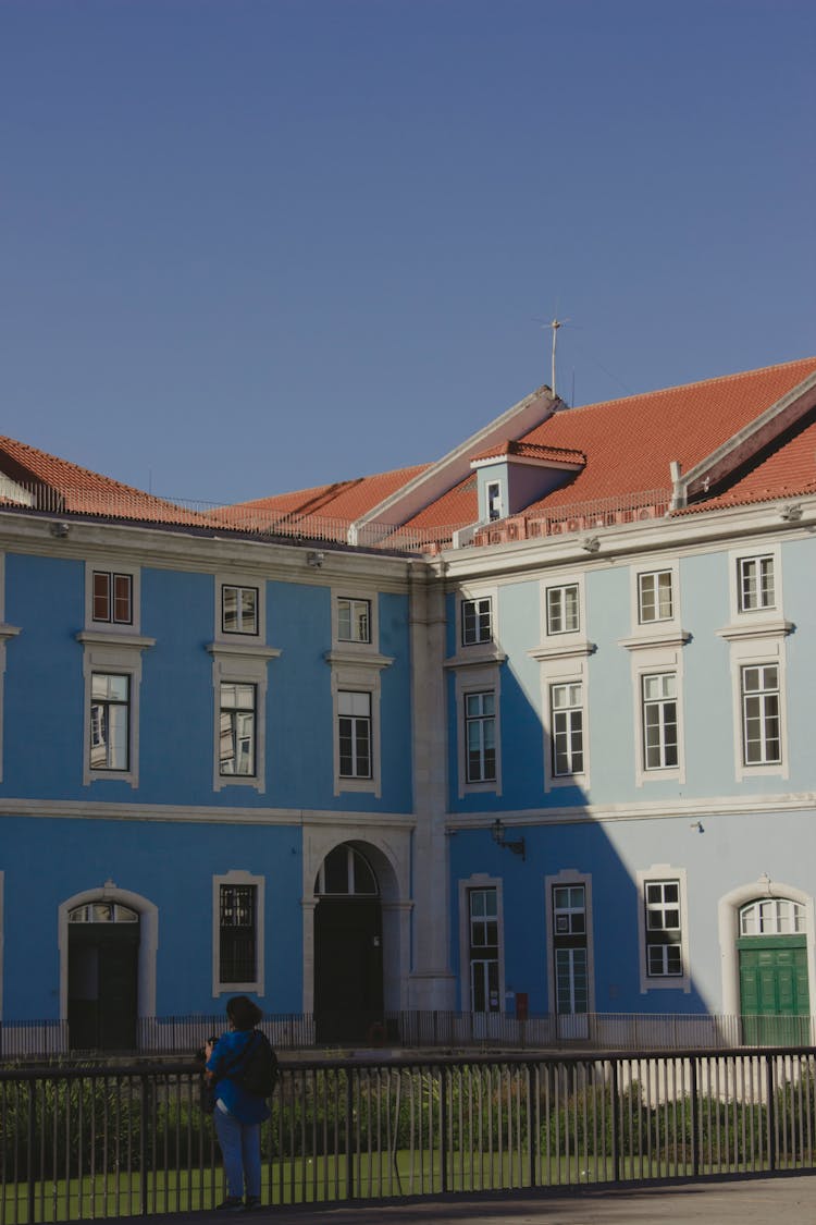 Woman Standing Near Blue Building