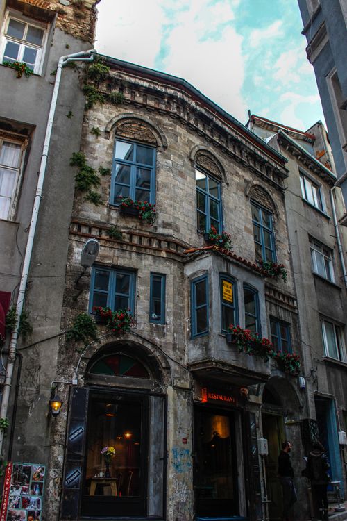 Free Explore the charming old stone facade with ivy and windows in Istanbul's urban street setting. Stock Photo