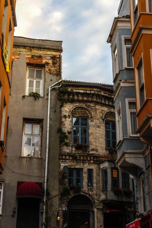Free Explore the timeless beauty of Istanbul through these charming historic buildings in a bustling street setting. Stock Photo