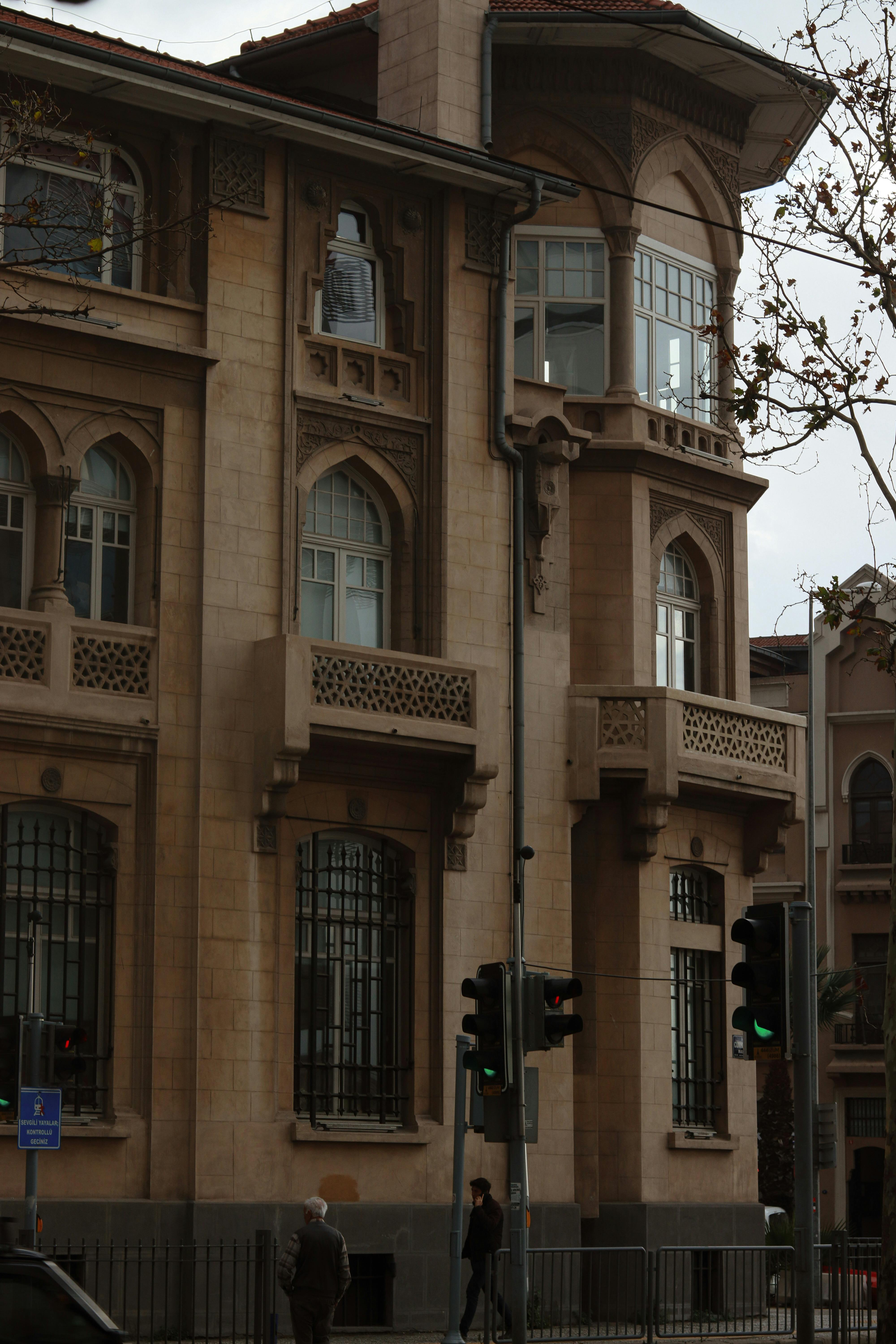 a man walks past a building with a clock on it