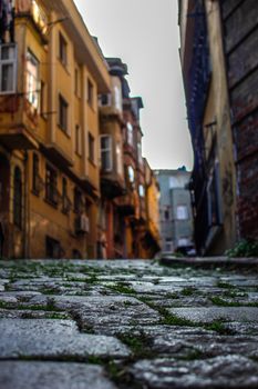 Rustic cobblestone street in Istanbul with historic buildings capturing urban charm.