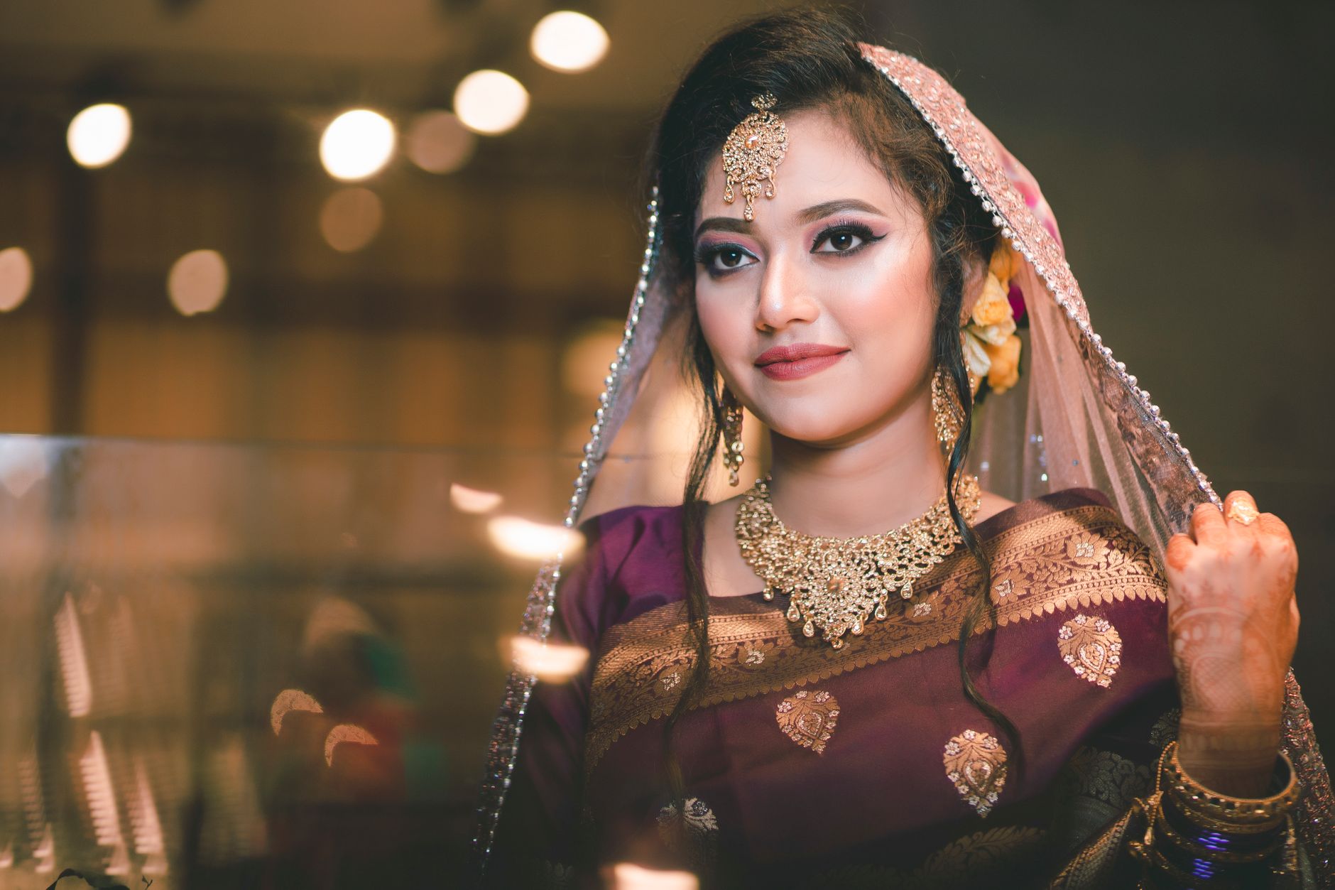Stunning portrait of a Bangladeshi bride adorned with traditional jewelry and attire, exuding elegance and grace.