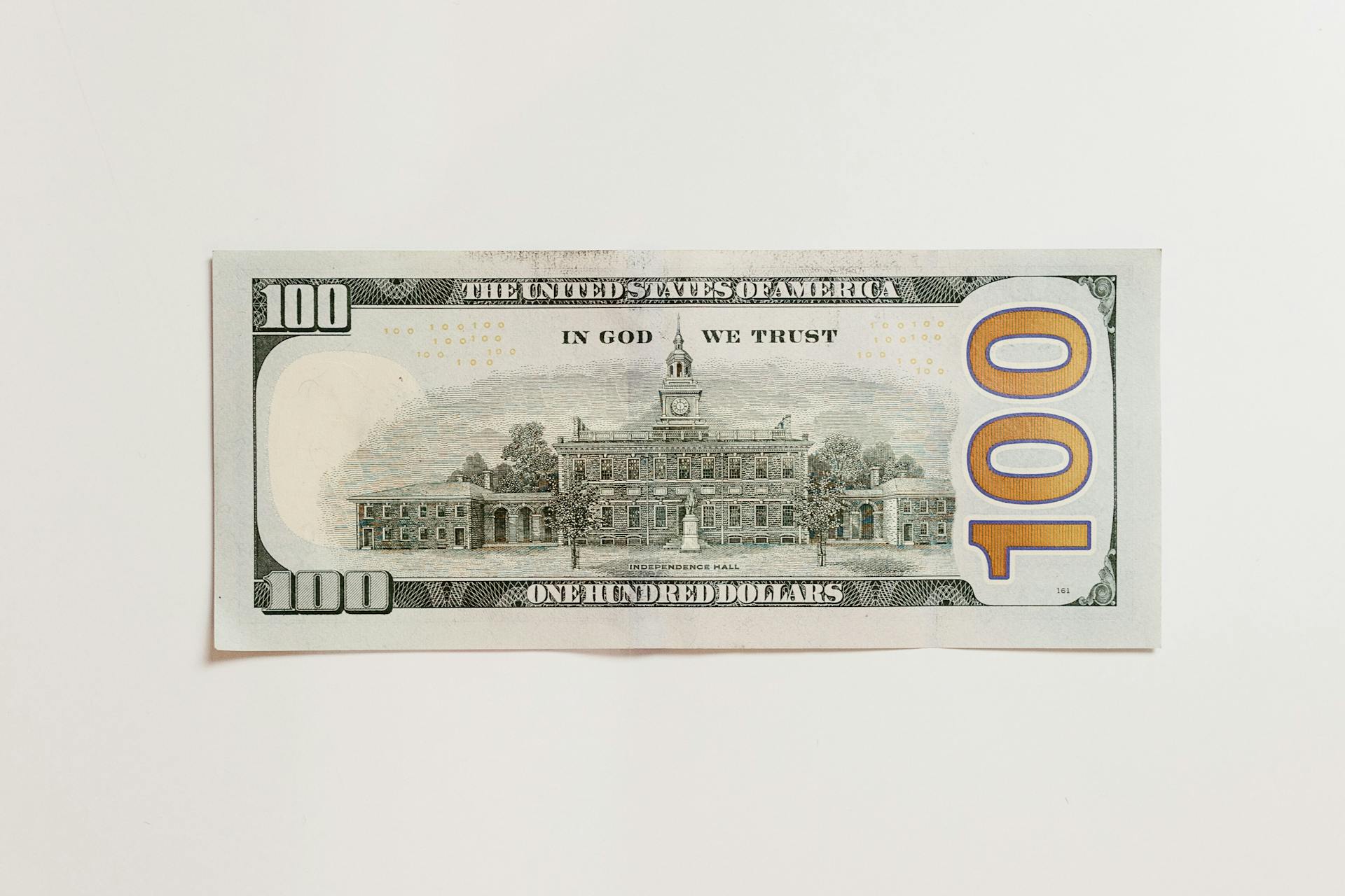 Close-Up Shot of a Paper Money on White Surface