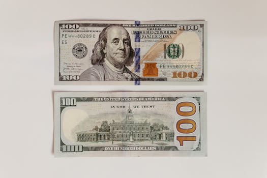 High-resolution image of a hundred dollar bill showing both front and back on a white surface.