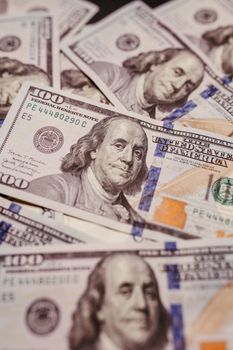 High-resolution shot of US hundred dollar bills laid out, showcasing Benjamin Franklin.